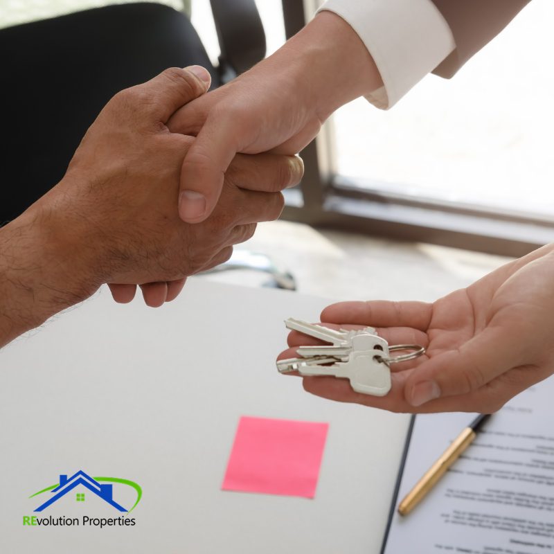 Property manager handing over keys to new tenant at Revolution Properties